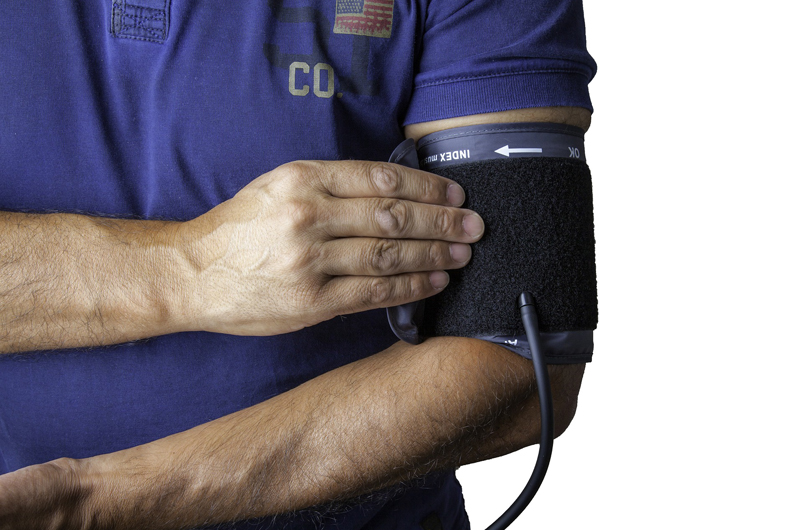 A patient wearing a blood pressure cuff.